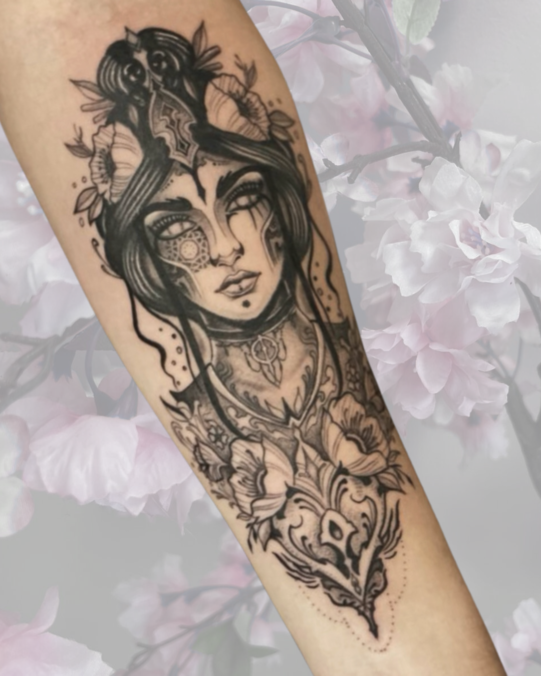 Black and grey illustrative woman with florals on forearm