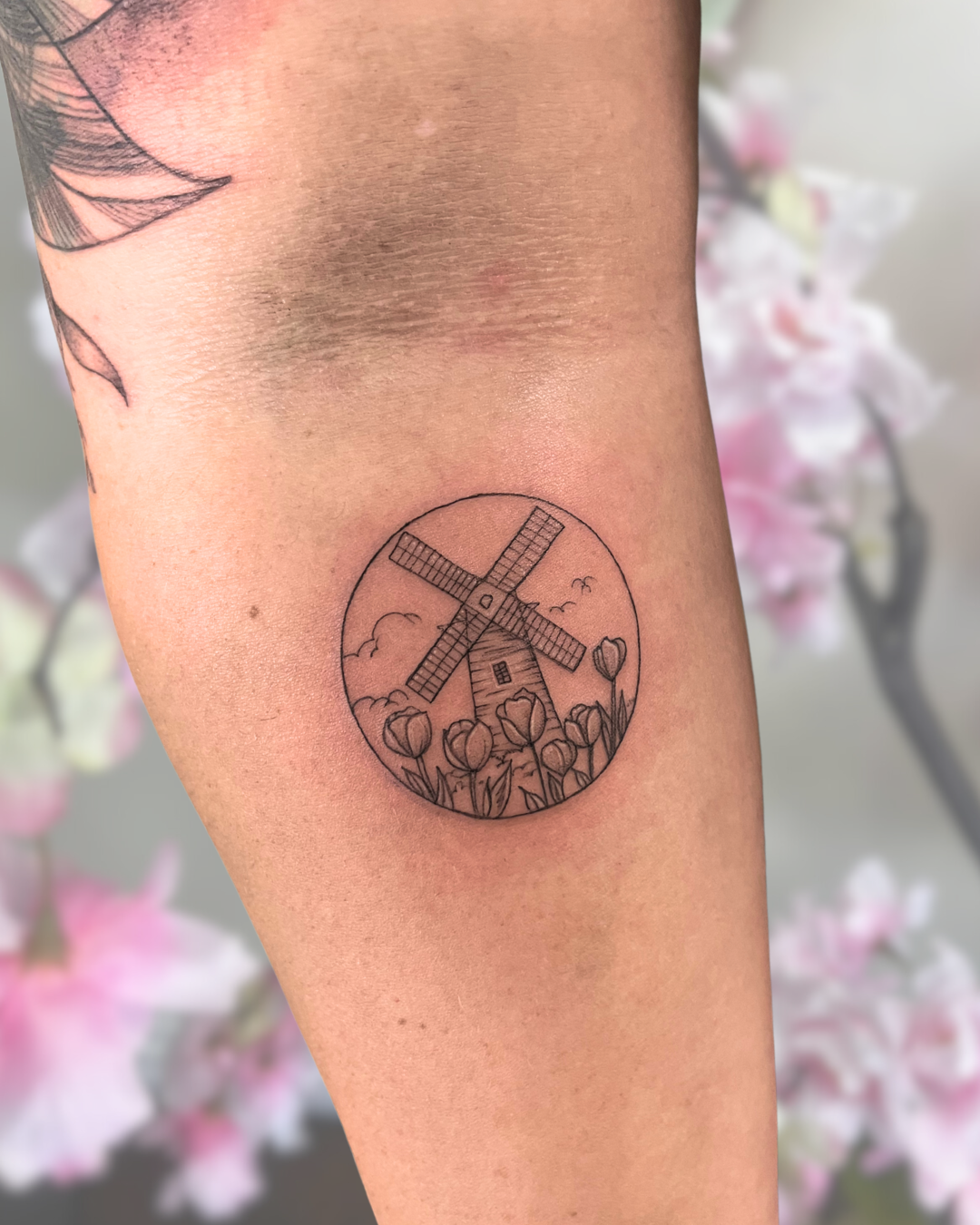 Fine line windmill and tulips on arm