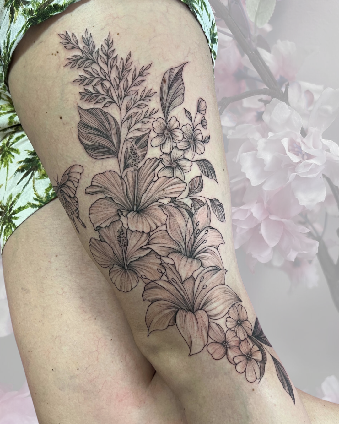 Fine line floral thigh piece with hibiscus and lilies